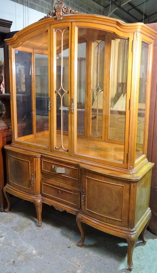 A modern stained beech display cabinet, with mirror back over two drawer base on cabriole supports, 143cm wide x 140cm high.