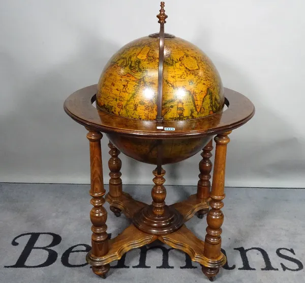 A 20th century globe drinks cabinet, on turned supports, 73cm diameter x 100cm high.