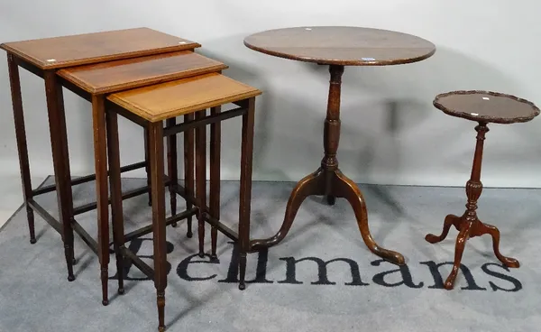 A late 19th century oak tripod table on downswept supports, 59cm diameter x 67cm high, a Regency style mahogany wine table, 29cm wide x 53cm high, and