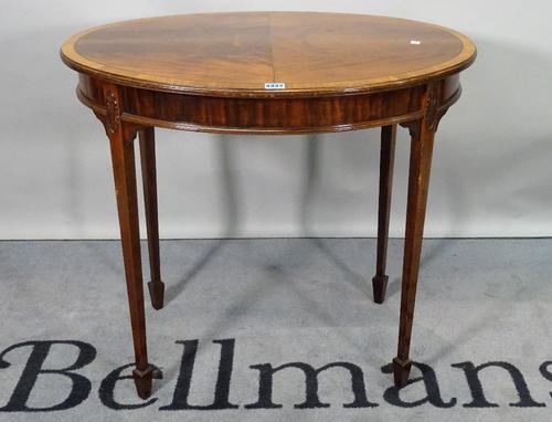An Edwardian mahogany oval centre table, on tapering square supports, 77cm wide x 69cm high.