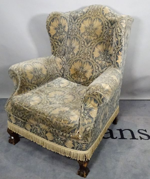 A Victorian style hardwood framed wingback armchair, on ball and claw supports, 106cm high x 86cm wide.