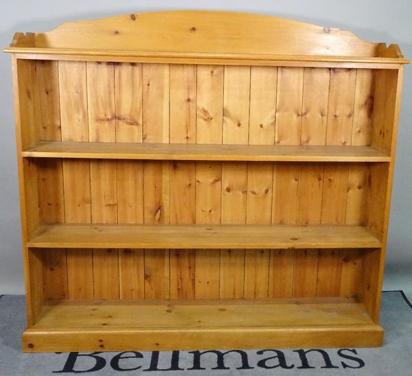 A modern pine three tier open bookcase, on plinth base, 158cm wide x 140cm high.