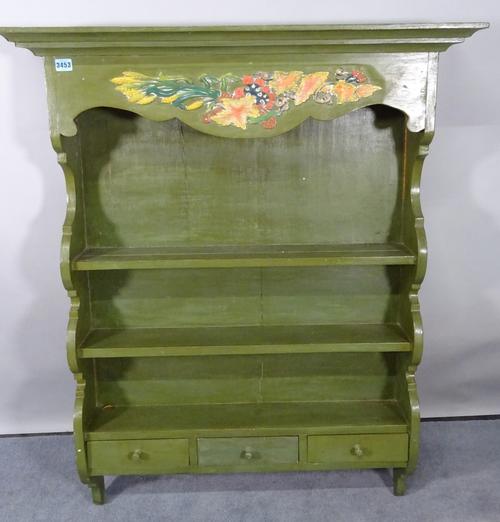 An early 20th century green painted three tier hanging plate rack, with three frieze drawers, 93cm wide x 115cm high.