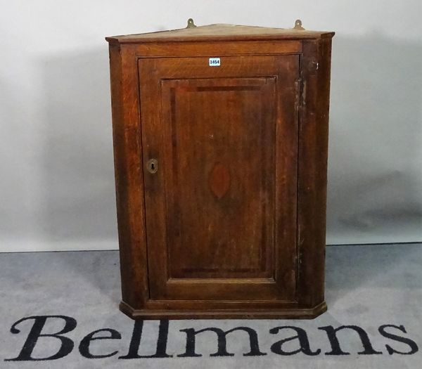 A late 18th century hanging corner cupboard, 70cm wide x 90cm high.