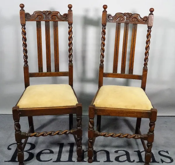 A set of four 18th century style oak highback dining chairs, 45cm wide x 108cm high. (4)