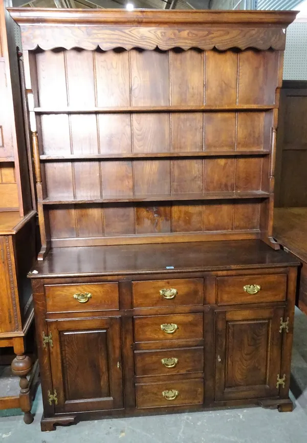 A modern oak dresser, with three tier plate rack over six short drawer cupboard base, 122cm wide x 184cm high.
