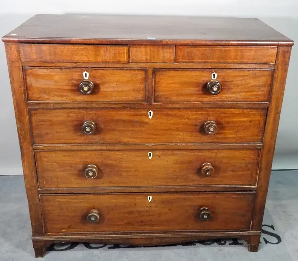 A George III mahogany chest, with two flush drawers over two short and three long graduated drawers, on ogee bracket feet, 111cm wide x 108cm high.
