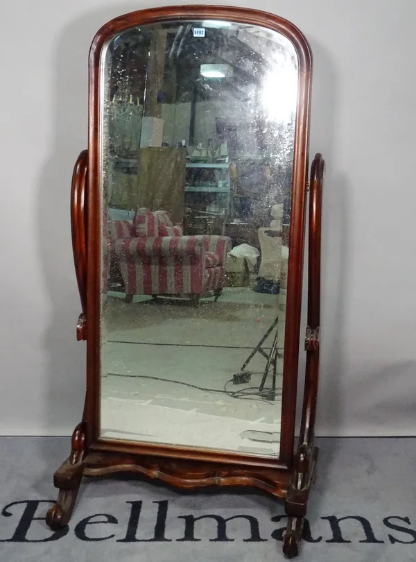 A late Victorian mahogany cheval mirror, with bevelled glass and scrolling supports, 73cm wide x 150cm high.
