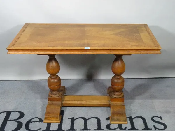 An 18th century style oak centre table, on turned supports united by an H-frame stretcher, 96cm wide x 68cm high.