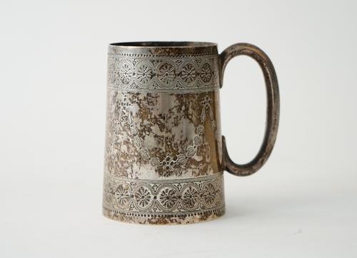 A Victorian silver christening mug, of tapered cylindrical form, with a 'C' shaped handle, with engraved decoration, maker Barnard family, London 1873