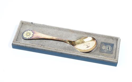 A Georg Jensen silver gilt and yellow enamelled spoon, detailed 1973, the handle having a yellow flowerhead finial,  import mark London 1973, length 1