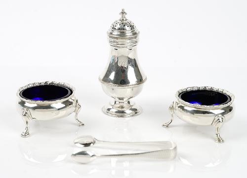 Silver, comprising; an early George III pepper caster of baluster form, London 1763, a pair of George III salts, each of circular form, raised on thre