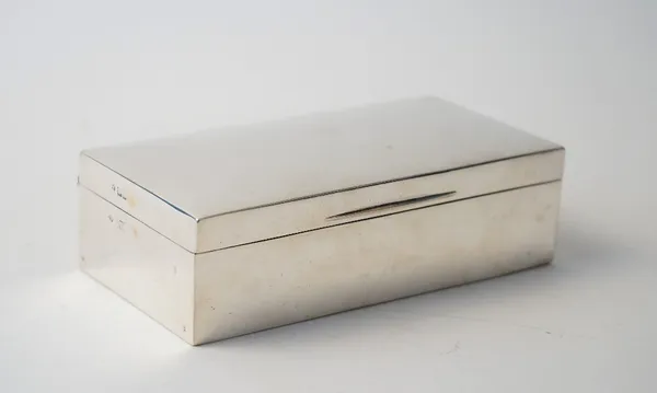 A silver rectangular table cigarette box, wooden lined within, with two adjustable divisions, London 1905, size 17.5cm x 9cm.