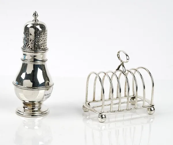 Silver, comprising; a seven bar toastrack, having a loop handle, raised on four spherical feet, London 1905 and a baluster shaped sugar caster, raised