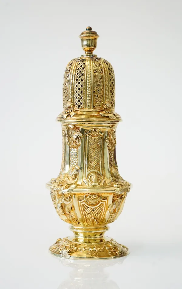 A silver gilt sugar caster, decorated in the Rococo style, with foliate scrolling motifs in the manner of Paul De Lamerie, London 1904, with a later A