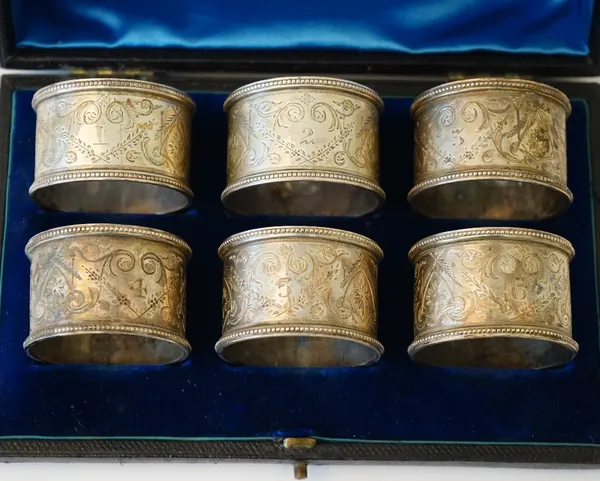 Six Victorian silver napkin rings, each with engraved decoration within beaded rims, numbers 4,5 & 6, London 1893, numbers 1,2 & 3 London 1895, combin