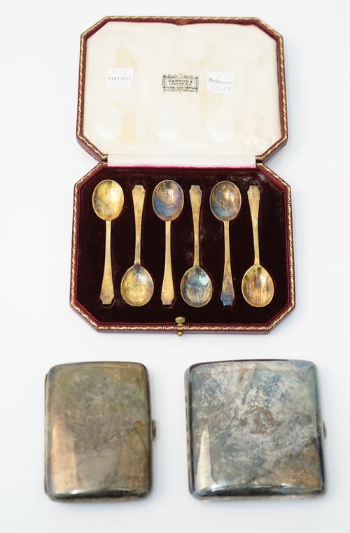 Silver, comprising; a set of six coffee spoons, London 1939, having a gilt finish, with a case and two rectangular cigarette cases, Birmingham 1894 an