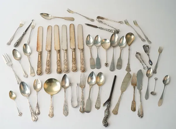 A group of mostly American Sterling flatware, comprising; two pairs of sugar tongs, two butter knives, three various forks, a set of six pastry forks,