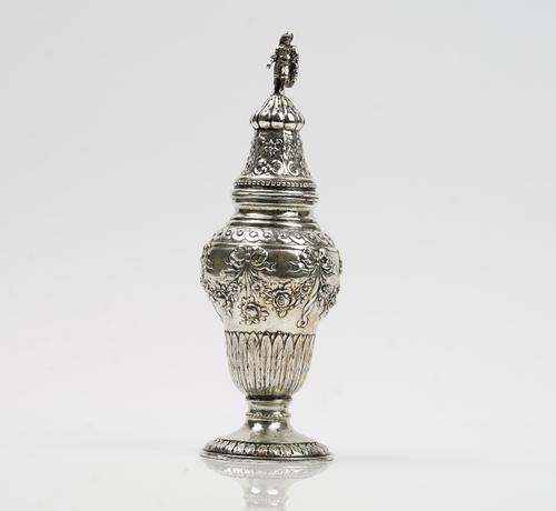 A German sugar caster, of inverted pear shaped form, decorated with floral swags, having ribbon tied bow surmounts, the top with a standing figure fin