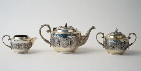An Indian three piece tea set, comprising; a teapot, the hinged lid with an elephant finial, a twin handled sugar bowl, the hinged lid with a elephant