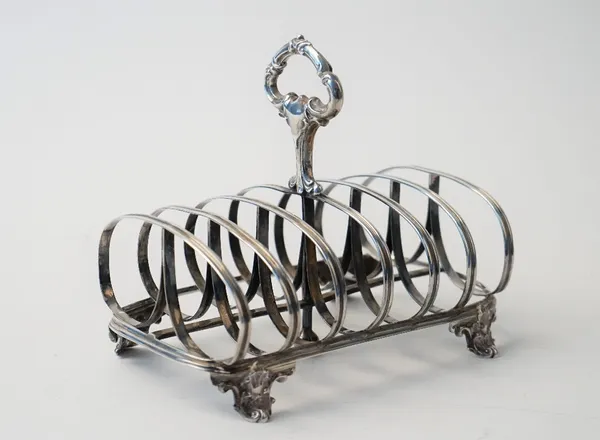 A Victorian silver seven bar toastrack, with a loop shaped handle, raised on four scrolled feet, London 1858, weight 247 gms.