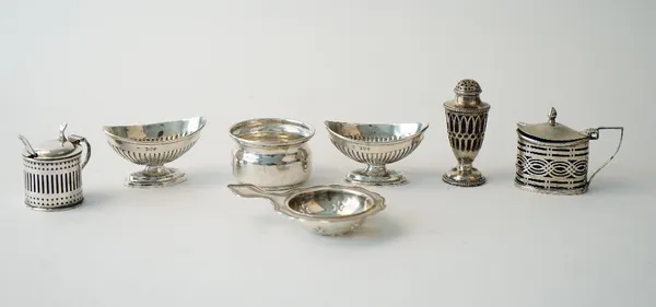 Silver, comprising; an oval mustard pot, Chester 1899, another mustard pot, London 1893, with two blue glass liners, a mustard spoon, Birmingham 1938,