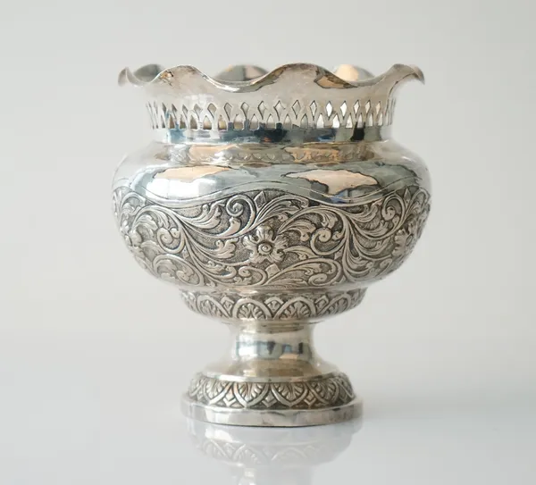 A foreign vase with floral and foliate scroll embossed decoration, otherwise with pierced decoration below a wavy rim, possibly Asian, height 15cm, we