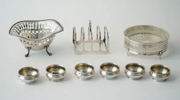 Silver, comprising; a set of six American small circular salts, detailed Sterling, a five bar toastrack of angular form, Birmingham 1961, a Sterling b