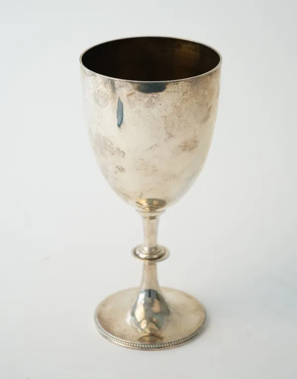 A Victorian silver trophy goblet, raised on a circular foot, decorated with a beaded rim, London 1890, height 21.5cm, weight 247 gms.