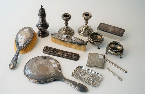 Silver and silver mounted wares, comprising; a sugar caster, Birmingham 1916, a shaped rectangular trinket dish, London 1898, a cigarette case, a pair
