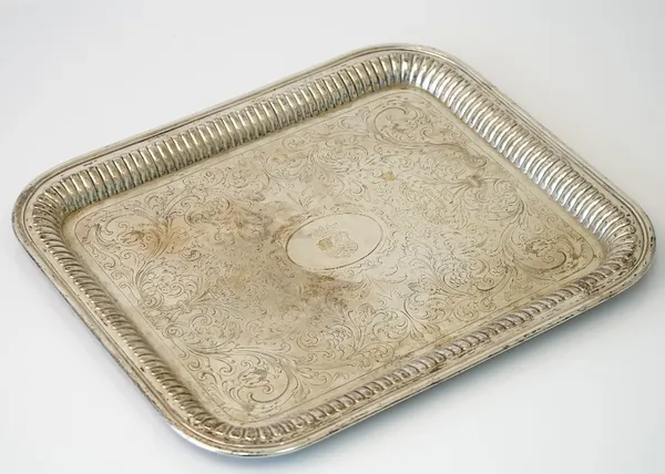 A German rectangular tray, engraved with a shield within an oval surround to the centre, otherwise with fruiting and engraved scrolling decoration wit