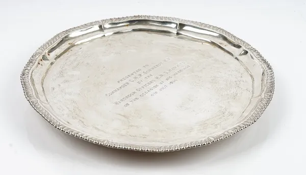 A Chinese salver, of shaped circular form, decorated with a gadrooned rim, raised on three floral feet, presentation inscribed, diameter 36cm, weight