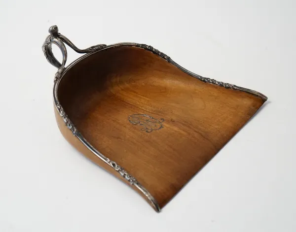 A French silver mounted walnut crumb tray, applied with an initial monogram to the centre, the mount and the handle decorated with floral and foliate