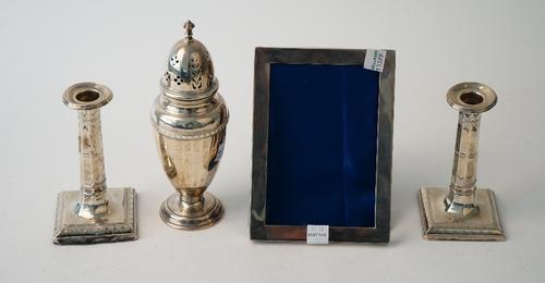 Silver and silver mounted wares, comprising; a sugar castor  Birmingham 1930 137gms, a pair of candlesticks each with a faceted stem and raised on a s