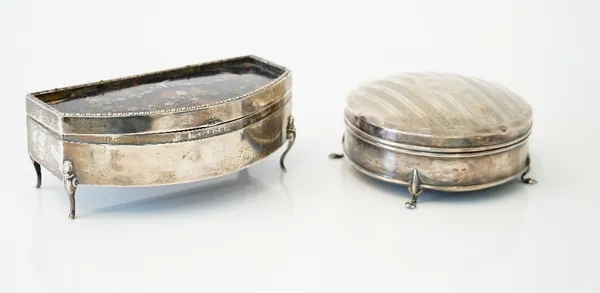 A silver hinge lidded circular trinket box, the domed lid decorated with engine turned bands, raised on four paw feet, Birmingham 1911 and a silver an