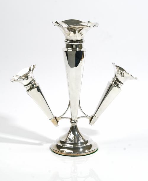 A silver table centrepiece stand, designed as three trumpet shaped vases, with the principal vase to the centre, raised on a loaded circular foot, She