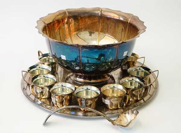 A silver plated punch bowl, having a shaped rim and panelled sides, a King's pattern punch ladle, a circular tray with foliate scrolling decoration an