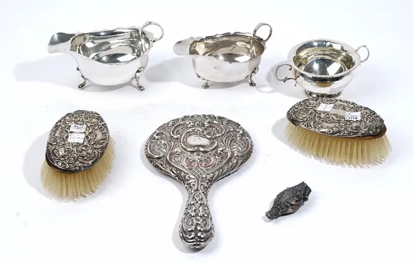 Silver and silver mounted wares, comprising; two sauceboats, a twin handled sugar bowl, combined weight 282 gms, also a hand mirror and two hairbrushe