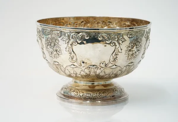 A late Victorian sliver rose bowl, embossed with fruit, foliate scrolls and flowers, raised on a circular foot, diameter 24cm, Birmingham 1896, weight