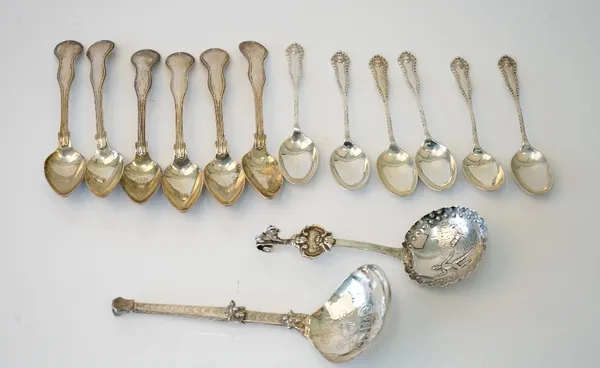 A set of six silver teaspoons, having decorated handles, Sheffield 1911, a set of six European thread pattern teaspoons, a Dutch silver fork combined