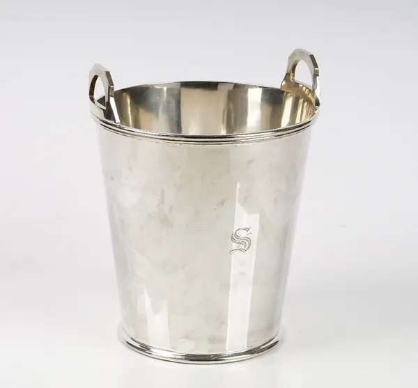 A silver twin handled wine cooler, of tapered cylindrical form, having angular handles above a reeded band, Sheffield 1975, height 24cm, weight 1495 g