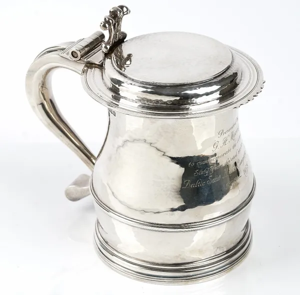 A late Victorian Britannia standard silver, large hinge lidded tankard, the body of baluster form, the flat hinged lid with a cast thumb piece and scr