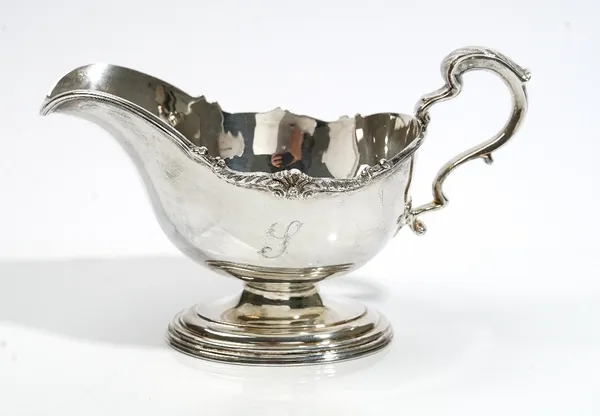 A silver large sauceboat, with a scrolling handle, shaped rim and raised on an oval foot, Sheffield 1969, weight 352 gms.