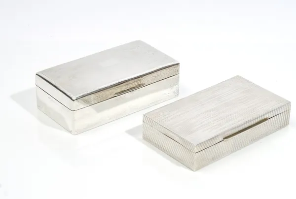 Silver, comprising; a rectangular table cigarette box, wooden lined within, the hinged lid engine turned, the sides plain (the hallmark rubbed), 17.5c