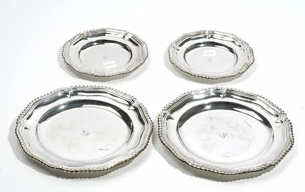 Silver, comprising; a pair of shaped circular dishes, each decorated with a gadrooned rim, Sheffield 1967, diameter 18.5cm and another pair of shaped