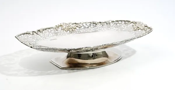 A silver fruit dish, of tapered oval form, the wide rim cast and pierced with fruiting vine, length 41.5cm, Sheffield 1977, weight 1245 gms.