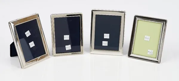 A near pair of silver mounted plain rectangular photograph frames, Sheffield 1985 and 1986 and two further silver mounted rectangular photograph frame