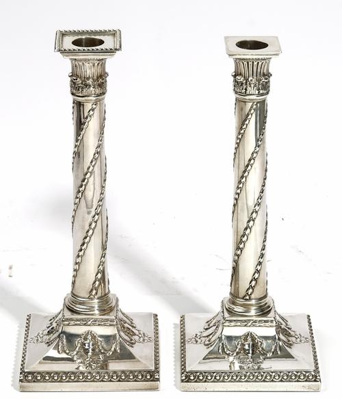 A matched pair of George III silver candlesticks, one by John Parsons & Co, Sheffield 1791, one by J Wilson & Co, Sheffield 1775, the cylindrical tape