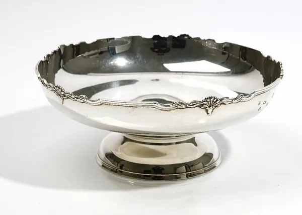 A silver centrepiece bowl, of circular form, the cast shaped rim with palmette motifs at intervals, raised on a circular foot, by Cooper Brothers, She