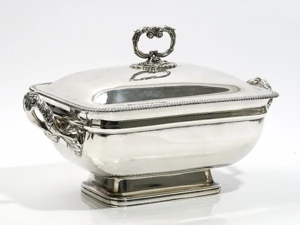 A George III silver twin handled tureen and cover, of curved rectangular form, in the classical style, with boldly scroll decorated handles and with a